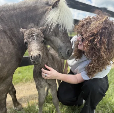 Tamera visiting a local farm with a miniature horse and foal.