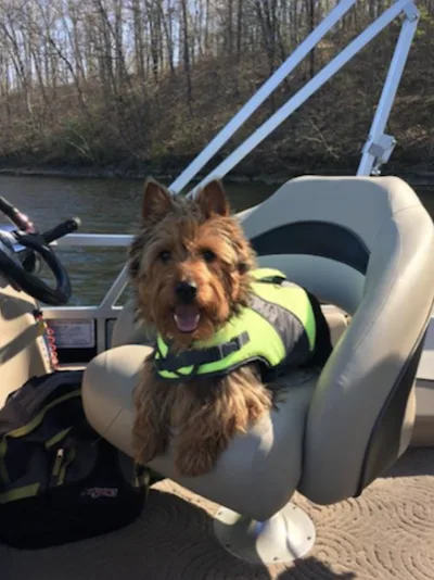 Captain Murphy in a life vest aboard a pontoon boat.