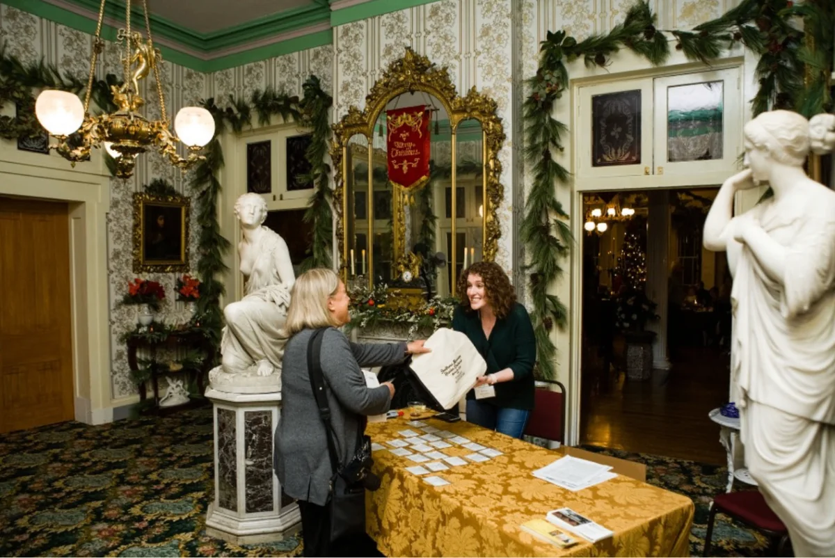 Guests checking in inside Belmont Mansion during the Southern Mansion Reader Weekend