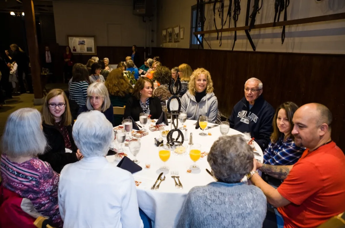 Southern Mansion Reader Weekend attendees gathered around a round dining table