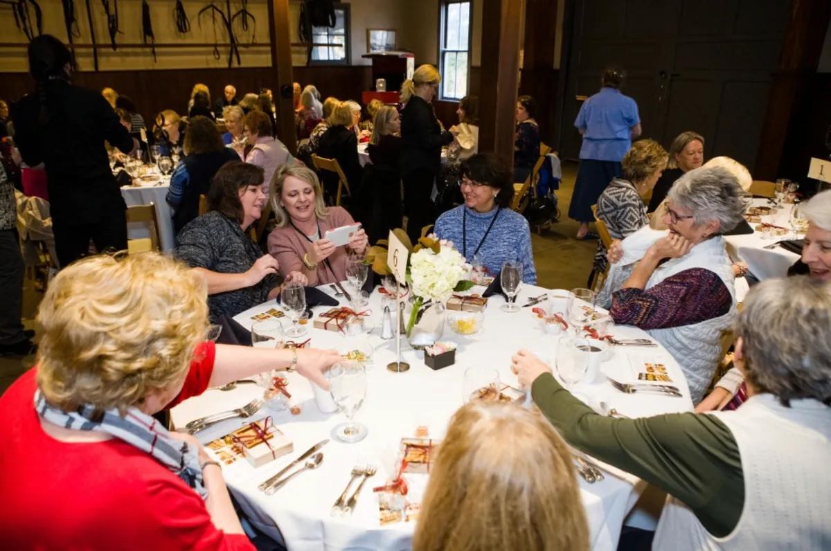 Guests sharing a photo together during dinner at the Southern Mansion Reader Weekend