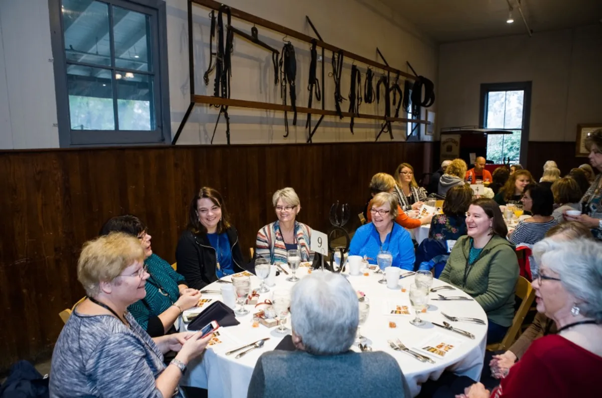 Southern Mansion Reader Weekend guests seated together beneath historic tack displays