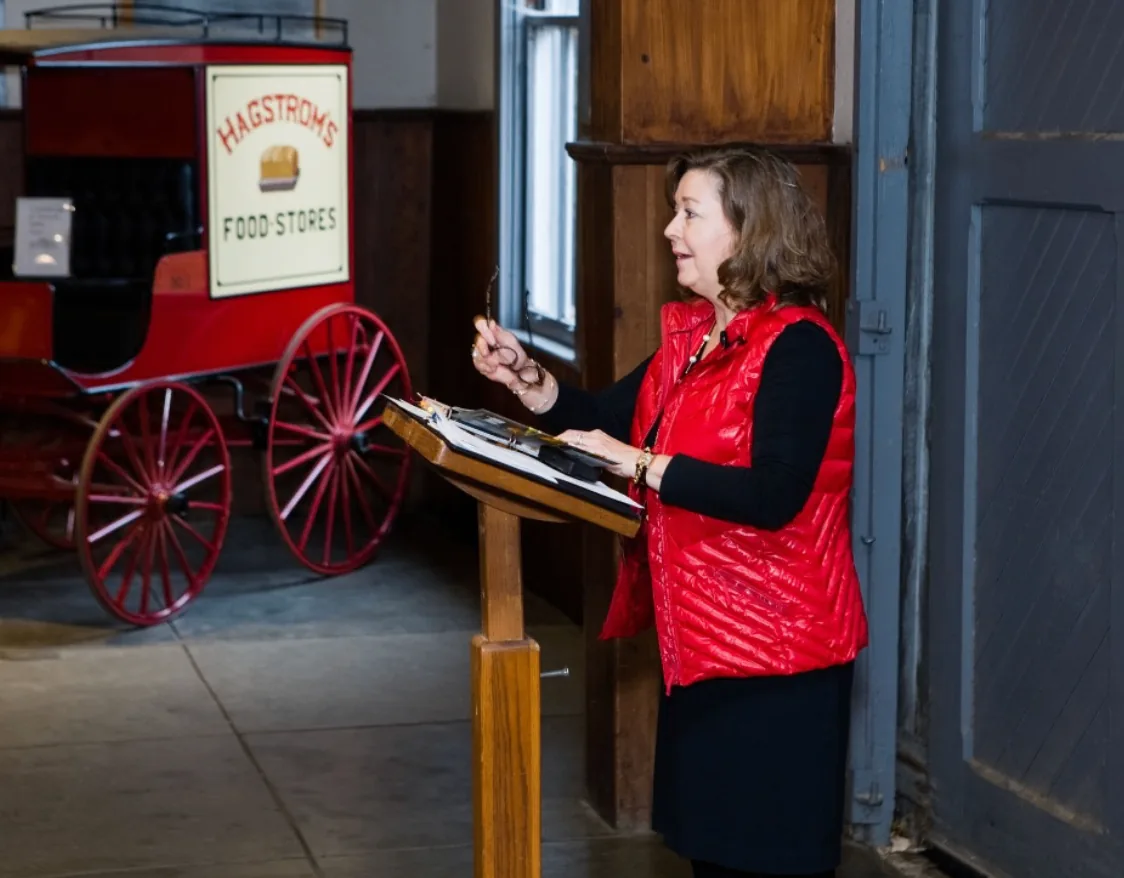 A speaker presenting at a lectern during the Southern Mansion Reader Weekend