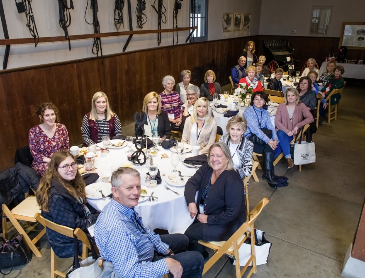 Southern Mansion Reader Weekend guests posing together around their dinner table