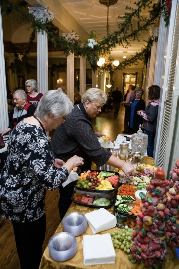 Reader Weekend guests enjoying the refreshment table inside Belmont Mansion