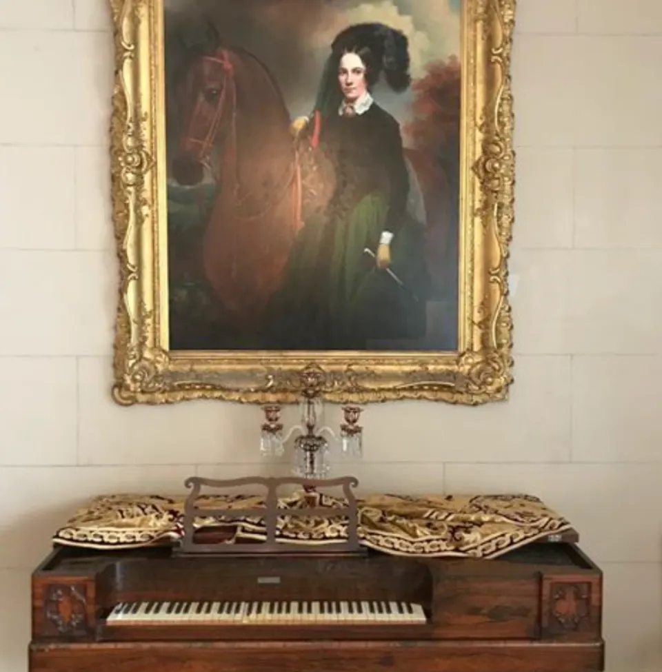 Portrait of Adelicia Acklen with her horse Bucephalus in a gilded frame inside Belmont Mansion.