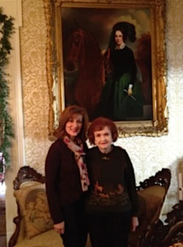 Tamera Alexander with Beverly Kaiser standing beneath Adelicia Acklen's portrait at Belmont Mansion.