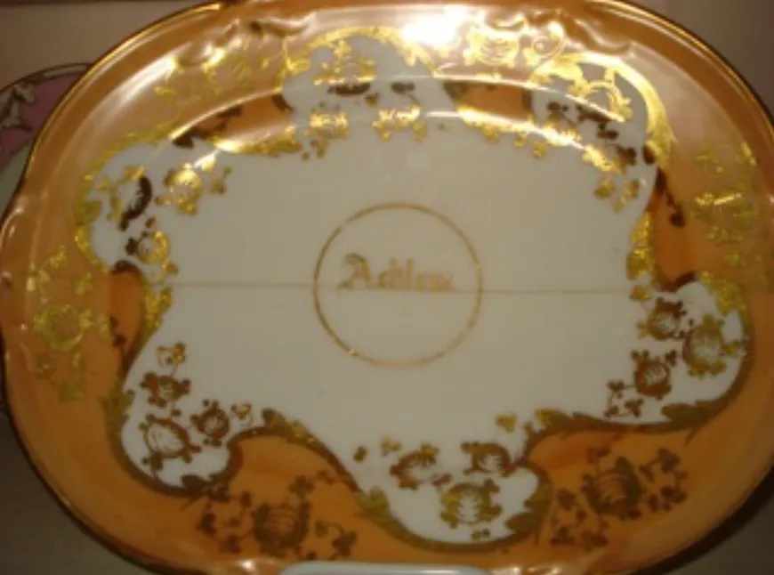 Hand-painted gold-edged china plate from one of Adelicia Acklen's sets.