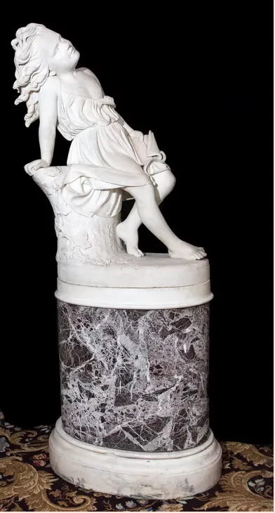 Sans Souci statue by C.B. Ives displayed on a marble pedestal.