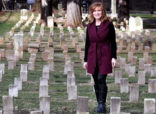Tamera Alexander walking among the headstones at McGavock Confederate Cemetery at Carnton in Franklin, Tennessee
