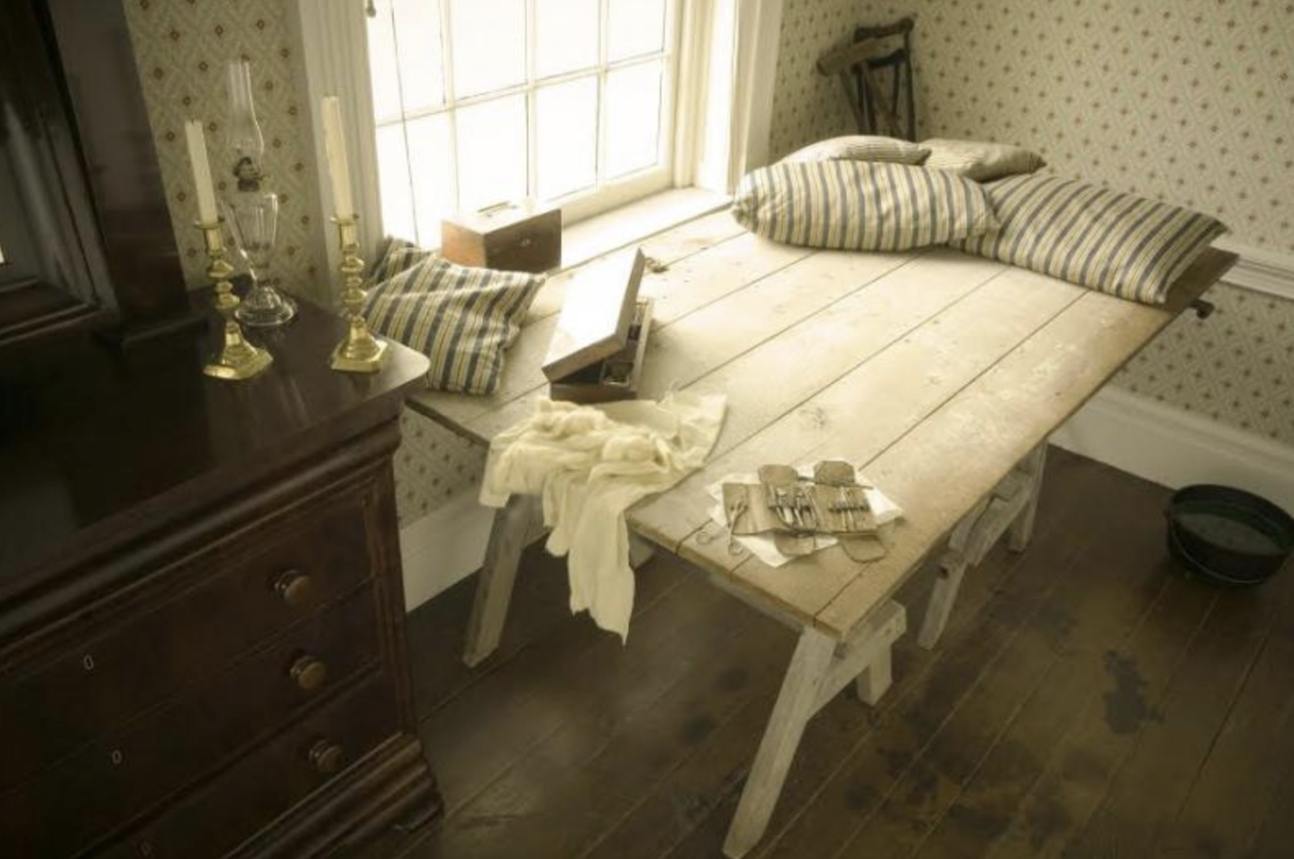 Surgeon's table set up in Winder's bedroom at Carnton with outline of surgeon's boots on the floor
