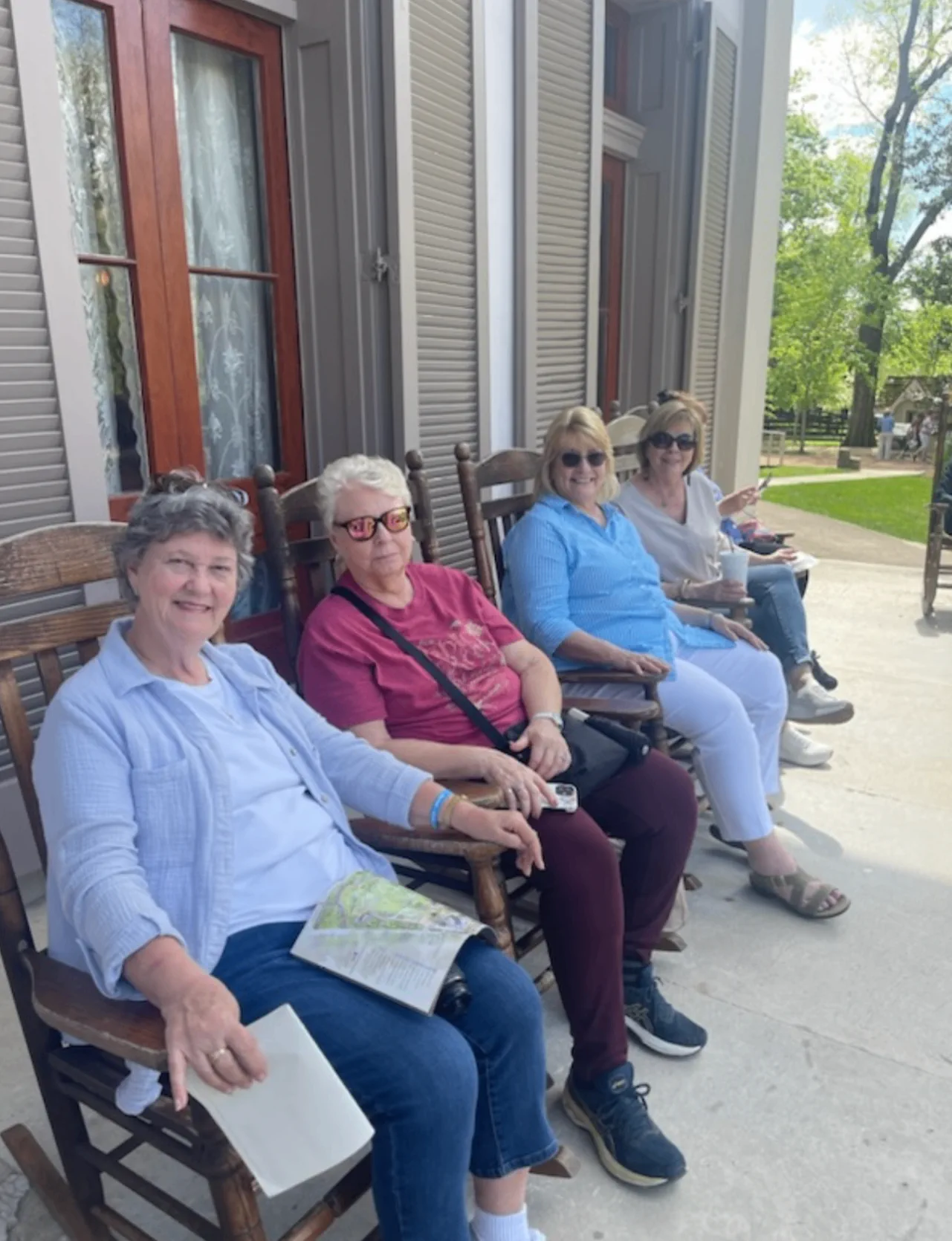 Book club visitors relaxing in rocking chairs during a Belle Meade visit.